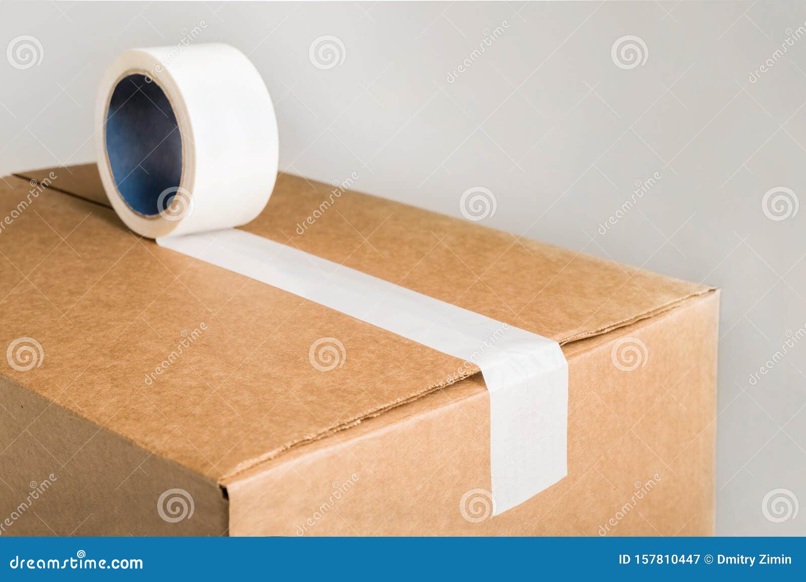 close up corrugared brown cardboard box white adhesive tape corrugared brown cardboard box white adhesive tape 157810447